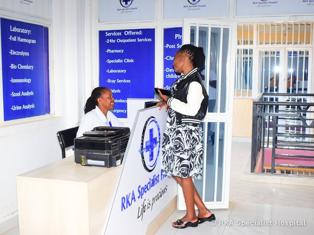 A receptionist serving a patient at RKA Specialist Hospital